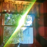 Green wavelength light emerges from a prism.